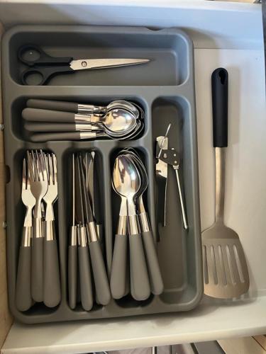 a tray filled with utensils sitting on a shelf at Modern Family home large garden free parking in Newcastle upon Tyne