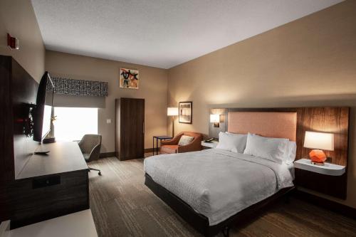 A bed or beds in a room at Hampton Inn Springfield