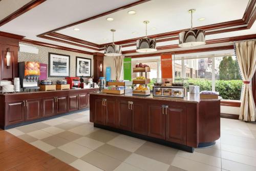 a large kitchen with wooden cabinets and a large window at Hampton Inn Dulles/Cascades in Sterling