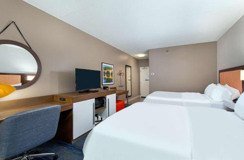 a hotel room with two beds and a desk at Hampton Inn Corbin in Corbin