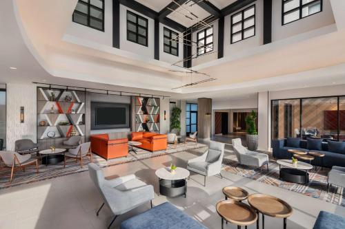 an open living room with furniture and a tv at DoubleTree by Hilton San Francisco South Airport Blvd in South San Francisco