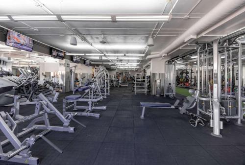a gym with several rows of treadms and machines at Hotelvetro Iowa City, Tapestry Collection By Hilton in Iowa City