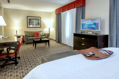 a hotel room with a bed and a desk at Hampton Inn & Suites Montgomery-Downtown in Montgomery