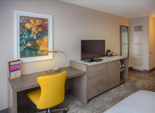 a desk with a yellow chair in a room at DoubleTree by Hilton Denver/Westminister in Westminster