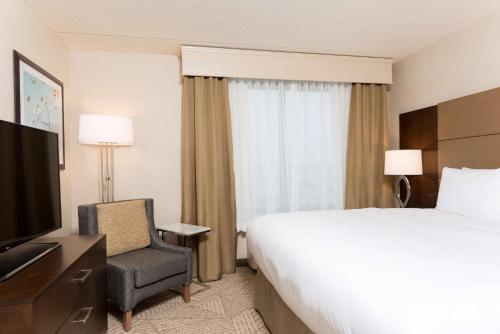 a hotel room with a bed and a television at Doubletree by Hilton Pleasant Prairie Kenosha, WI in Pleasant Prairie