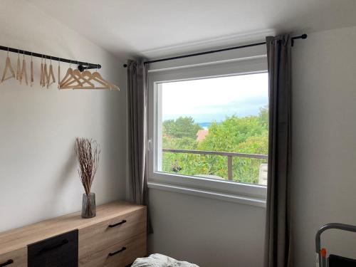 a bedroom with a large window with a view at Sun&Fun Vendégház in Balatonakarattya