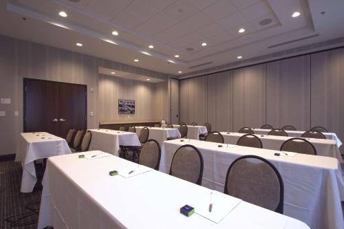 a conference room with white tables and chairs and a podium at Hampton Inn & Suites Columbus/University Area in Columbus