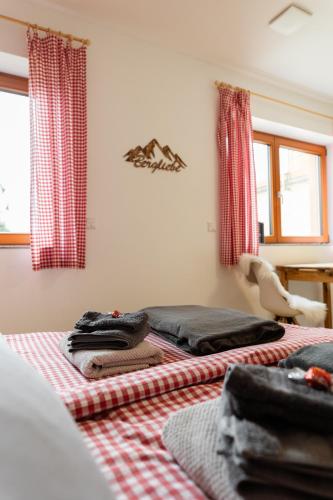 a room with two beds with red and white checked sheets at Chalet Winterberg in Winterberg