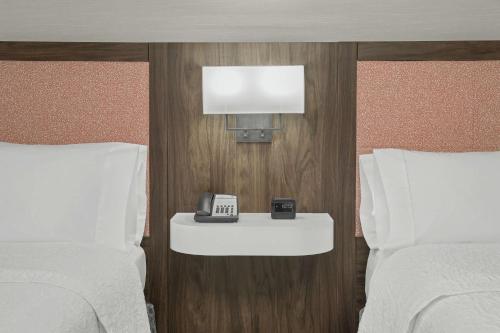 a hotel room with two beds and a telephone at Hampton Inn & Suites Macon I-75 North in Macon