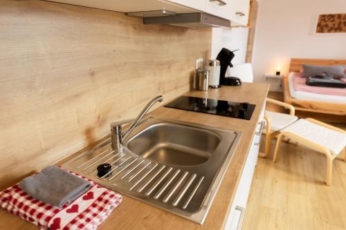 a kitchen with a stainless steel sink and a counter at Chalet Winterberg in Winterberg