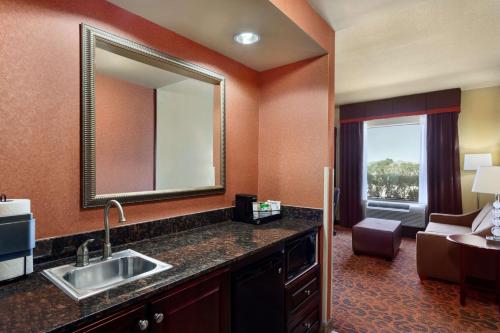 a hotel room with a sink and a mirror at Hampton Inn & Suites Mission in Mission