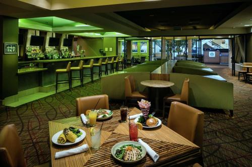 a restaurant with a table with food and a bar at Hilton Stockton in Stockton
