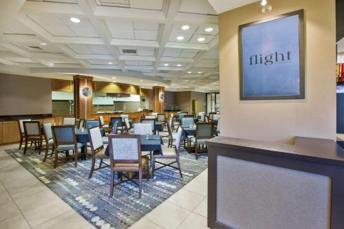 a restaurant with tables and chairs and a sign that reads flight at Embassy Suites Columbus - Airport in Columbus