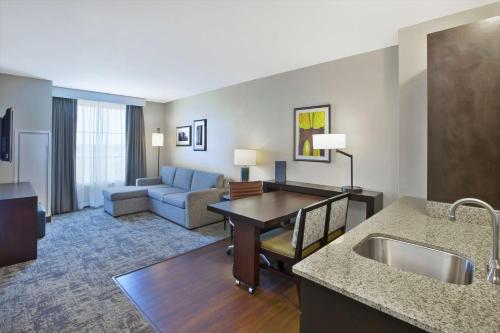 a hotel room with a kitchen and a living room at Embassy Suites Columbus - Airport in Columbus