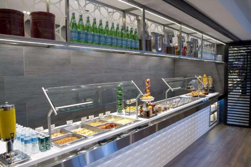 a buffet line with food and drinks in a restaurant at Hilton Montreal/Laval in Laval