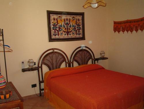 um quarto com uma cama com um cobertor vermelho em Saline em Favignana