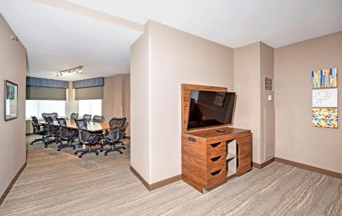 a conference room with a television and a table with chairs at Hampton by Hilton Ottawa in Ottawa