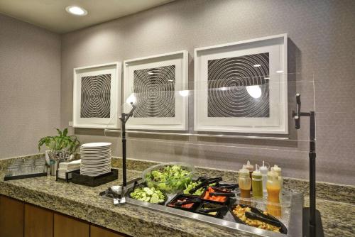 a kitchen with a sink with food on a counter at Homewood Suites Dallas-Frisco in Frisco