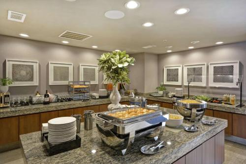 a kitchen with a counter with food on it at Homewood Suites Dallas-Frisco in Frisco