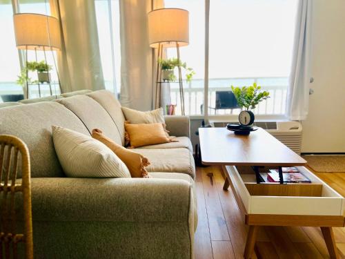 a living room with a couch and a coffee table at Beach Blessing - Oceanfront at Symphony Beach Club in Ormond Beach