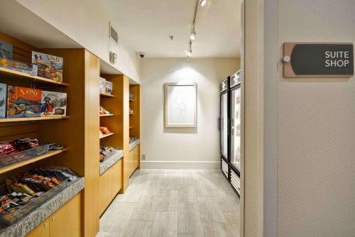 a hallway with a sun shop sign in a store at Homewood Suites Dallas-Frisco in Frisco