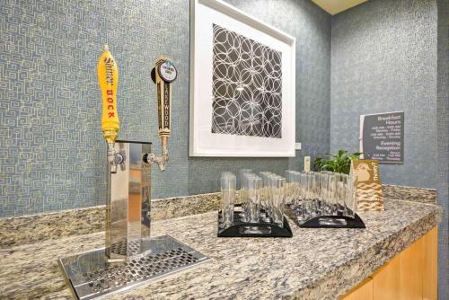 a counter with glasses on it in a room at Homewood Suites Dallas-Frisco in Frisco