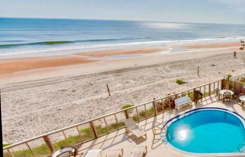 a view of the beach from the balcony of a resort at Beach Blessing - Oceanfront at Symphony Beach Club in Ormond Beach