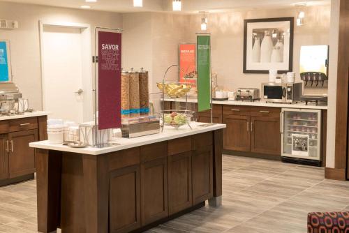 a large kitchen with a counter in a store at Hampton Inn & Suites Bay City in Bay City