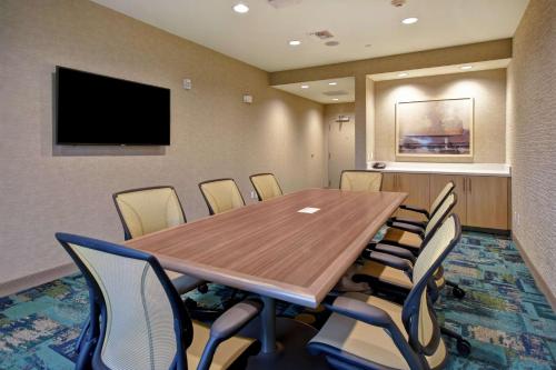 a conference room with a wooden table and chairs at Home2 Suites by Hilton Harvey New Orleans Westbank in Harvey