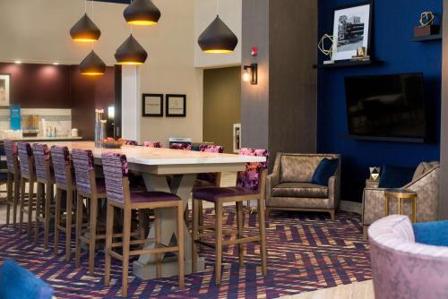 a dining room with a large table and chairs at Hampton Inn & Suites Warrington Horsham in Warrington