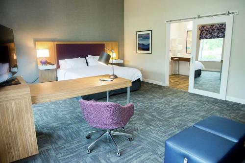 a hotel room with a bed and a desk and a chair at Hampton Inn & Suites Warrington Horsham in Warrington