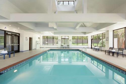 a swimming pool with blue water in a building at Homewood Suites Williamsburg in Williamsburg