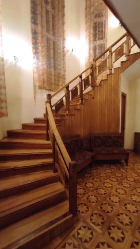 a wooden staircase in a building with a stair case at Гаварский уют in Gavarr