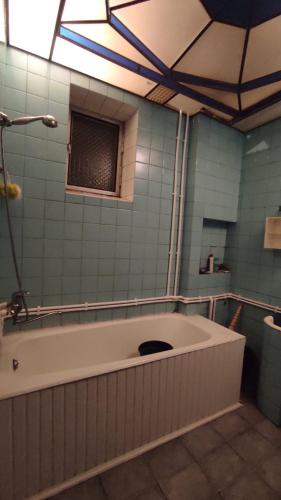 a large bath tub in a bathroom with a window at Гаварский уют in Gavarr