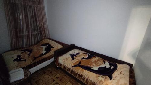 two beds in a corner of a room at Гаварский уют in Gavarr