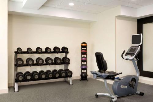 a gym with a rack of dumbbells and a treadmill at Homewood Suites Williamsburg in Williamsburg