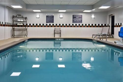 a swimming pool with blue water in a gym at Hilton Garden Inn Birmingham SE/Liberty Park in Birmingham