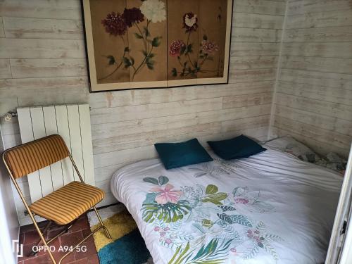mały pokój z łóżkiem i krzesłem w obiekcie Maison Cocooning, bord de Sèvre Nantaise w mieście Nantes