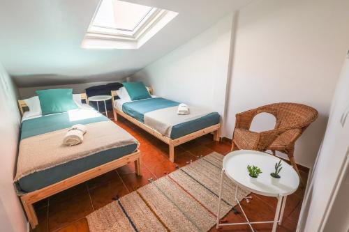 a room with two beds and a table and chairs at SandyBeachApartment in Porto Santo