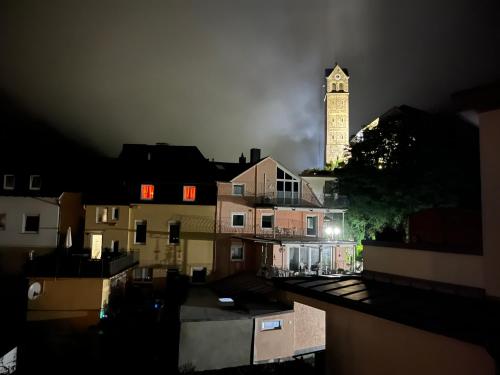a clock tower in the background of a city at night at Dolcevita in Bad Bertrich