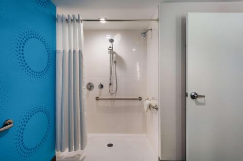 a bathroom with a shower with a shower curtain at Tru By Hilton Radford in Christiansburg