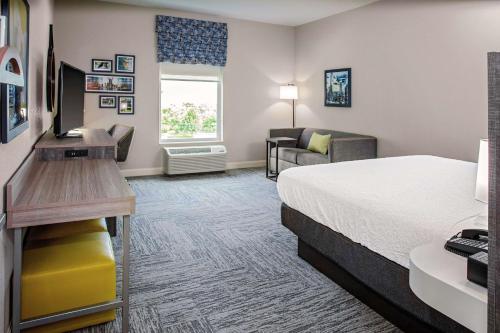 a hotel room with a bed and a desk at Hampton Inn Cranbury in Cranbury