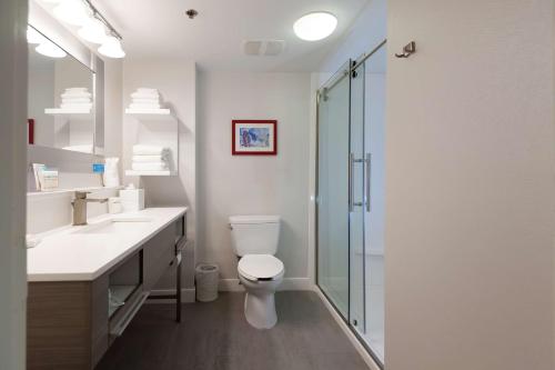 a bathroom with a toilet and a glass shower at Hampton Inn East Windsor in East Windsor
