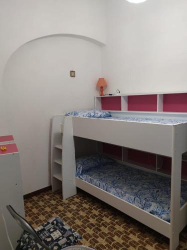 a bedroom with two bunk beds in a room at Sagittario House in Torre delle Stelle