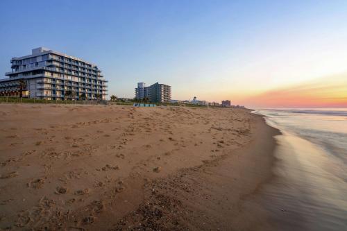 a view of the beach with buildings in the background at DoubleTree by Hilton Ocean City Oceanfront in Ocean City