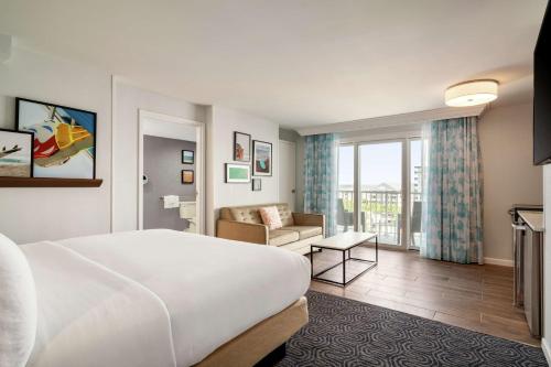 a hotel room with a bed and a couch at DoubleTree by Hilton Ocean City Oceanfront in Ocean City