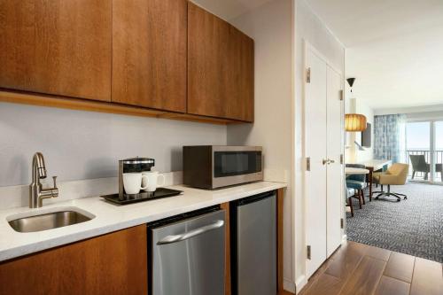 a kitchen with a sink and a microwave at DoubleTree by Hilton Ocean City Oceanfront in Ocean City