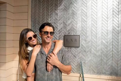 a man and a woman standing in front of a sign at Oceana Santa Monica, LXR Hotels & Resorts in Los Angeles