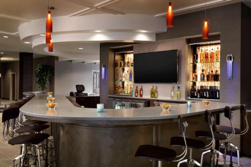 a bar in a hotel room with stools at DoubleTree by Hilton Hotel Oklahoma City Airport in Oklahoma City