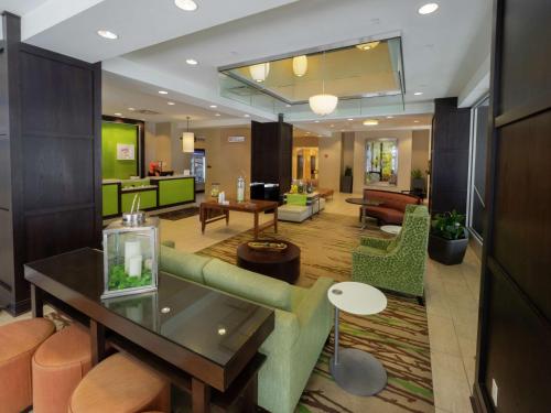 a living room with a couch and a table at The Hilton Garden Inn Buffalo-Downtown in Buffalo